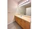 Bright bathroom vanity with light wood cabinets and a large mirror at 8338 S Independence Cir # 104, Littleton, CO 80128