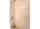 Close-up of the tub and shower featuring white tiles at 8338 S Independence Cir # 104, Littleton, CO 80128
