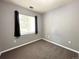 Cozy bedroom with neutral carpet and window with black curtains at 8338 S Independence Cir # 104, Littleton, CO 80128