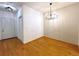 Charming dining area with hardwood floors and modern chandelier lighting at 8338 S Independence Cir # 104, Littleton, CO 80128