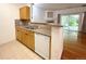 Well-lit kitchen featuring granite counters and wood cabinetry at 8338 S Independence Cir # 104, Littleton, CO 80128