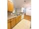 Cozy kitchen area adjacent to the living space with wooden cabinets and granite countertops at 8338 S Independence Cir # 104, Littleton, CO 80128