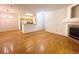 Inviting living room with hardwood flooring, fireplace and open to the kitchen area at 8338 S Independence Cir # 104, Littleton, CO 80128