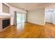 Bright living room featuring hardwood floors, a fireplace, and access to the outside at 8338 S Independence Cir # 104, Littleton, CO 80128