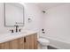 Well-lit bathroom with stylish fixtures, bathtub/shower combo, and modern vanity at 2530 Chase, Edgewater, CO 80215