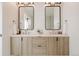 Bright bathroom features a double vanity, framed mirrors, and modern lighting at 2530 Chase, Edgewater, CO 80215