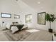 Sunlit bedroom with a vaulted ceiling, area rug and large windows at 2530 Chase, Edgewater, CO 80215