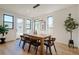 Light-filled dining room with a wooden table, modern light fixture, and access to the backyard at 2530 Chase, Edgewater, CO 80215