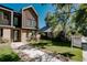 Modern three-story townhome featuring a well-maintained lawn and 'For Sale' sign at 2530 Chase, Edgewater, CO 80215
