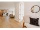 Bright foyer with hardwood floors, stylish mirror, and open view to the kitchen and living area at 2530 Chase, Edgewater, CO 80215