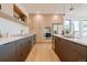 Modern kitchen featuring a kitchen island, stainless steel appliances, and wood cabinets at 2530 Chase, Edgewater, CO 80215