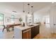 Open-concept kitchen with an island, dining area, and modern stainless steel dishwasher at 2530 Chase, Edgewater, CO 80215