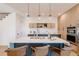 Modern kitchen featuring a large island, stainless steel appliances, and sleek, open shelving above backsplash at 2530 Chase, Edgewater, CO 80215