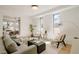 Bright living room featuring modern furnishings, hardwood floors, and natural light from large windows at 2530 Chase, Edgewater, CO 80215