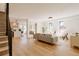 Open-concept living room with hardwood floors, a modern staircase, and views of the kitchen at 2530 Chase, Edgewater, CO 80215