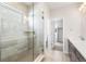 Bathroom featuring a tiled shower, a tiled floor and a quartz countertop at 8893 Springsong Ln, Littleton, CO 80125