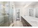 Bathroom featuring double vanity, quartz counters and modern glass-enclosed shower with bench at 8893 Springsong Ln, Littleton, CO 80125