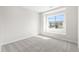 Bright bedroom with neutral carpet and large window offering neighborhood views at 8893 Springsong Ln, Littleton, CO 80125