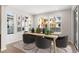 Bright dining room featuring a wooden table with seating and natural light at 8893 Springsong Ln, Littleton, CO 80125