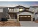 Charming two-story home with a two-car garage, stone accents, and a covered front porch at 8893 Springsong Ln, Littleton, CO 80125