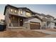 Charming two-story home with a two-car garage, stone accents, and a covered front porch at 8893 Springsong Ln, Littleton, CO 80125