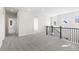 A bright hallway with neutral carpet leads to multiple rooms in the home at 8893 Springsong Ln, Littleton, CO 80125