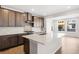A spacious kitchen is displayed with an island, stainless steel appliances, and ample counter space at 8893 Springsong Ln, Littleton, CO 80125