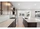 A bright kitchen features modern appliances, a spacious island, and sleek countertops at 8893 Springsong Ln, Littleton, CO 80125