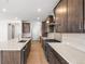 A contemporary kitchen features sleek countertops, stainless steel appliances, and wood flooring at 8893 Springsong Ln, Littleton, CO 80125