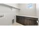 An efficient laundry room is equipped with storage cabinets and counter space at 8893 Springsong Ln, Littleton, CO 80125