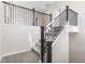 Carpeted staircase with dark wood railings, leading to the upper level of the home at 8893 Springsong Ln, Littleton, CO 80125