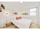 Cozy bedroom with a large bed, white walls, modern lighting, and natural light from a window at 3435 Lawrence St, Denver, CO 80205