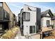 Contemporary home exterior with black and white design, featuring a walkway and landscaping at 3435 Lawrence St, Denver, CO 80205