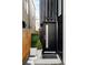 Modern black front door of a home, accented with landscaping and a side fence at 3435 Lawrence St, Denver, CO 80205