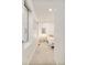 Bright hallway with neutral carpeting, white walls, and natural light, leading to a bedroom at 3435 Lawrence St, Denver, CO 80205