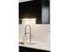 Close-up of the kitchen sink with modern faucet and white subway tile backsplash at 3435 Lawrence St, Denver, CO 80205