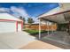 This backyard features a spacious patio, a well-maintained lawn, and a detached two-car garage at 1785 S Zuni St, Denver, CO 80223