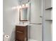 Bathroom featuring a vanity with a brown cabinet and a glass enclosed shower at 1785 S Zuni St, Denver, CO 80223