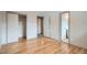 Bedroom with hardwood floors featuring closet and entrance to bathroom at 1785 S Zuni St, Denver, CO 80223