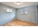 Cozy bedroom with hardwood floors, two windows, and a closet at 1785 S Zuni St, Denver, CO 80223