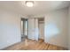 Bedroom with hardwood floors featuring closet and entrance to another room at 1785 S Zuni St, Denver, CO 80223