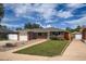 Charming brick home featuring a well-manicured front lawn, attached garage, and inviting curb appeal at 1785 S Zuni St, Denver, CO 80223