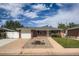 Charming brick home with a well-manicured lawn, front garden, and a detached garage at 1785 S Zuni St, Denver, CO 80223