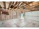 Spacious garage interior with unfinished walls and concrete floor, door to back yard at 1785 S Zuni St, Denver, CO 80223