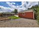 This image shows the side and back of the detached garage and garden in the backyard at 1785 S Zuni St, Denver, CO 80223