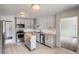 Well-lit kitchen featuring stainless steel appliances, modern cabinets, granite countertops, and a moveable kitchen island at 1785 S Zuni St, Denver, CO 80223