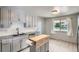 Beautiful kitchen featuring granite counters, light grey cabinetry, subway tile backsplash, and stainless steel appliances at 1785 S Zuni St, Denver, CO 80223