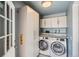 Laundry room with washer and dryer and storage cabinets at 1785 S Zuni St, Denver, CO 80223