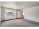Inviting living room with neutral walls, soft carpet, and a large window to let in natural light at 1785 S Zuni St, Denver, CO 80223