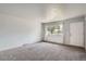 Spacious living room filled with natural light featuring neutral carpet and updated windows at 1785 S Zuni St, Denver, CO 80223